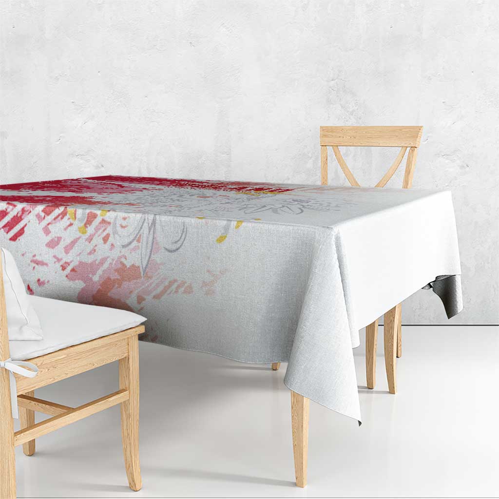 Red and white football-themed tablecloth draped over dining table with printed design