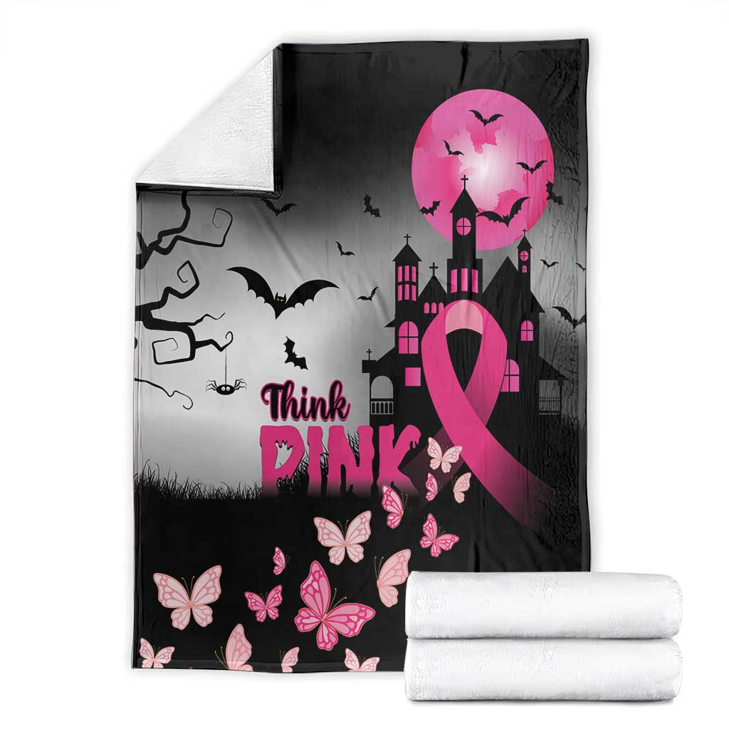 Black blanket with pink ribbon, butterflies, bats, and castle scene; folded with rolls