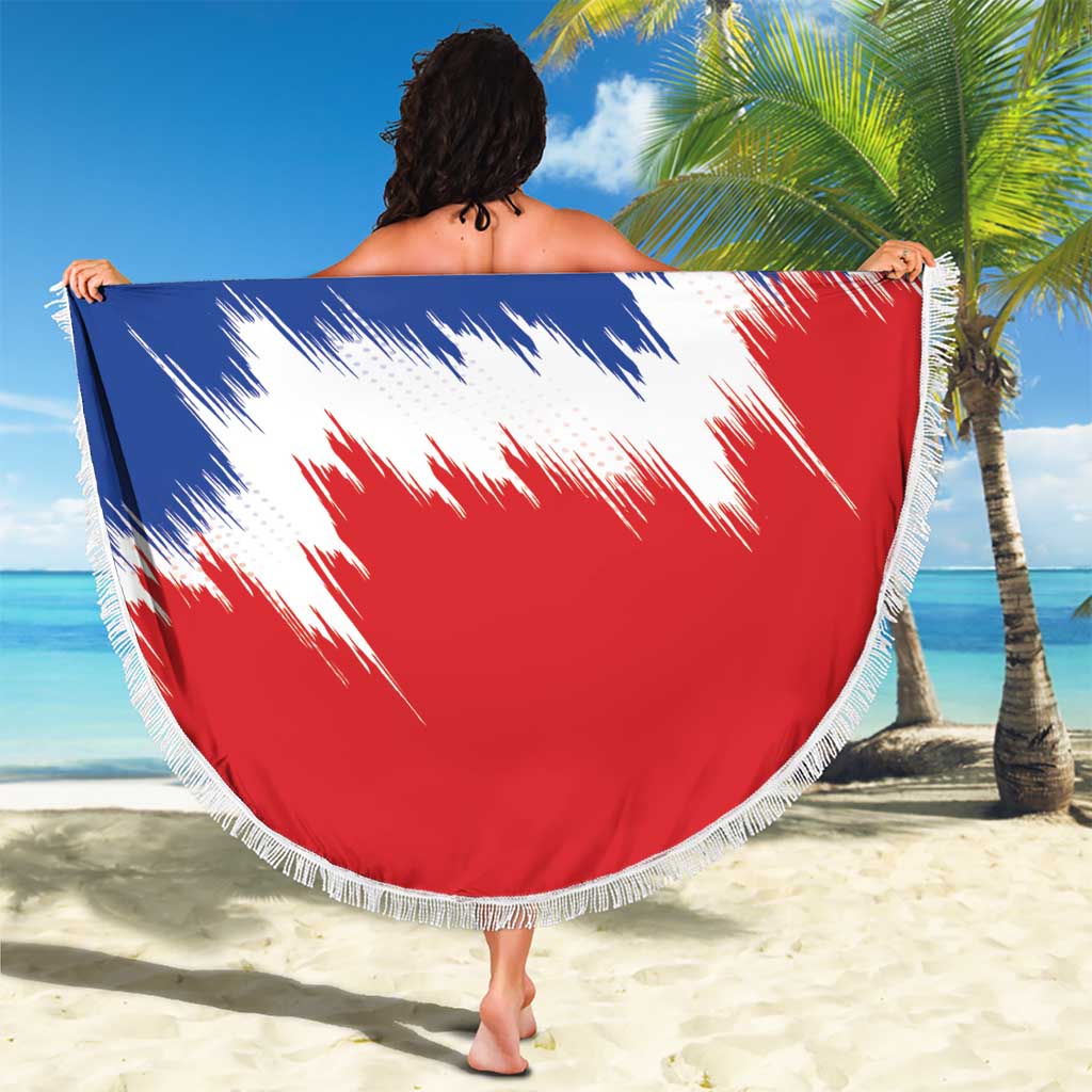 Round red-and-blue beach blanket with white streaks and fringe trim