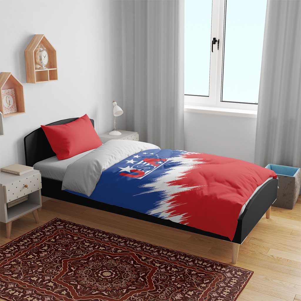 USA soccer bedding set on bed: blue and red comforter with star stripe graphic and red pillow