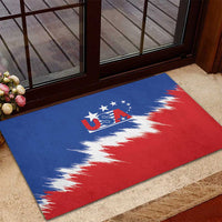 Blue rubber USA doormat with red and white splash flag near doorway