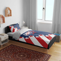 USA themed bedding set on bed: blue comforter with red-white diagonal stripe stars and pillows