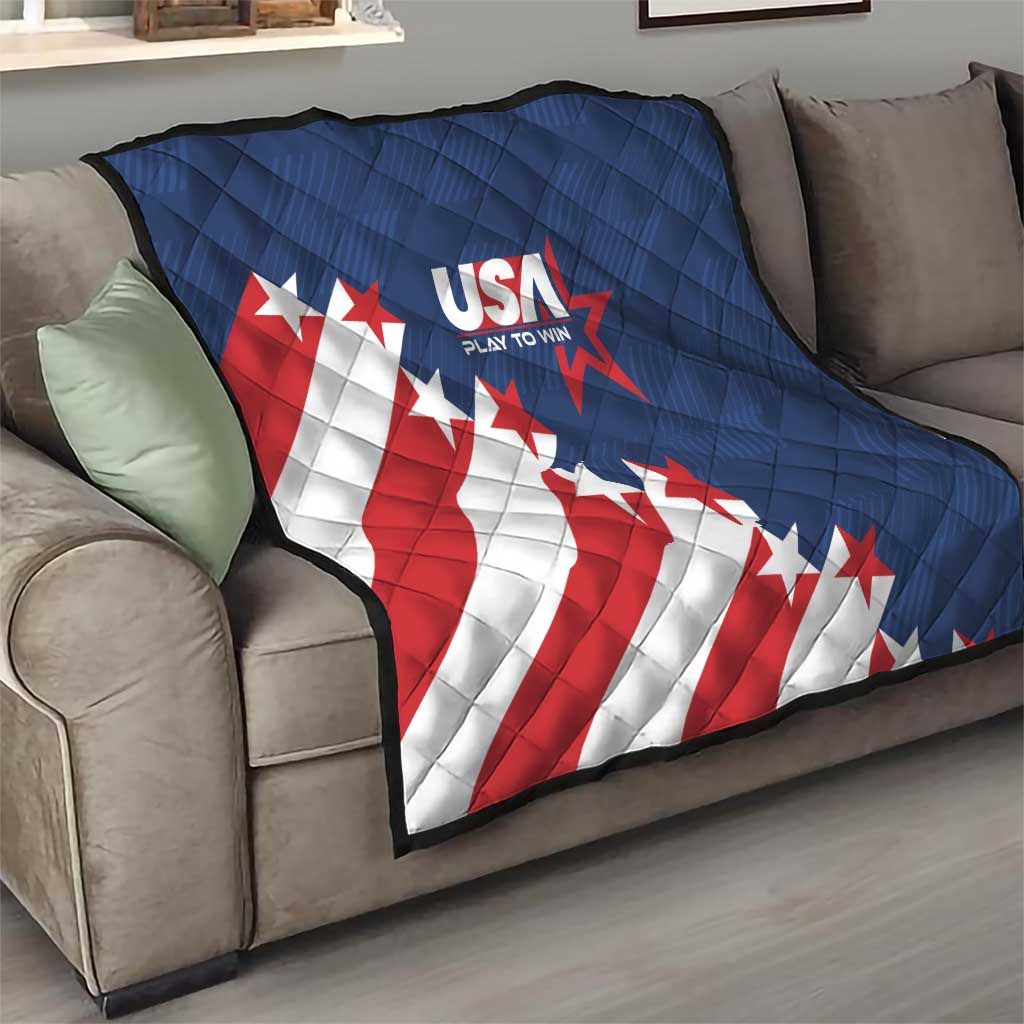 Blue quilt blanket with USA text and stars, red-and-white diagonal stripe pattern on couch