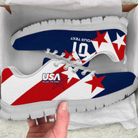 White and blue soccer sneakers with red star graphics and white rubber sole.