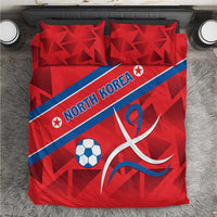 Red bedding set with North Korea text, soccer ball, and ribbon-style emblem, two pillows