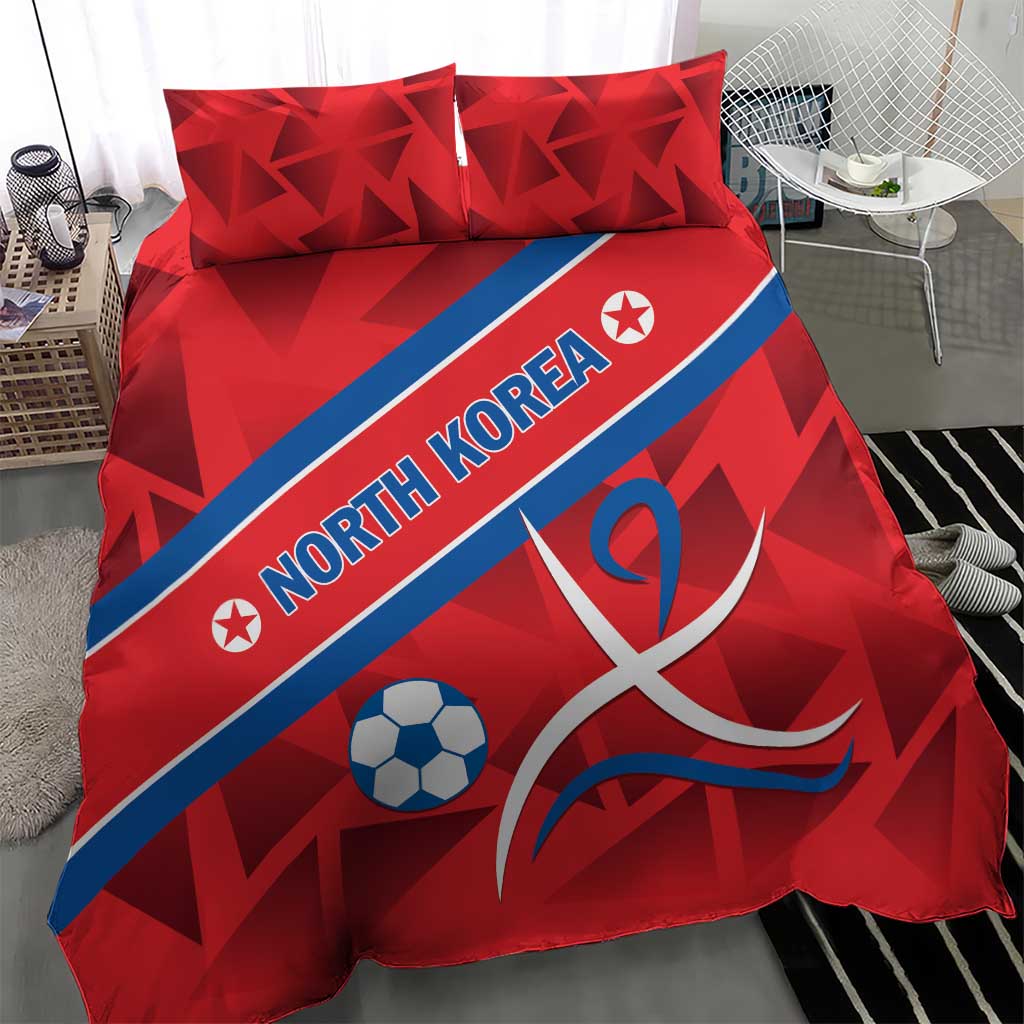 Red bedding set featuring North Korea text, soccer ball, and ribbon emblem, two matching pillows
