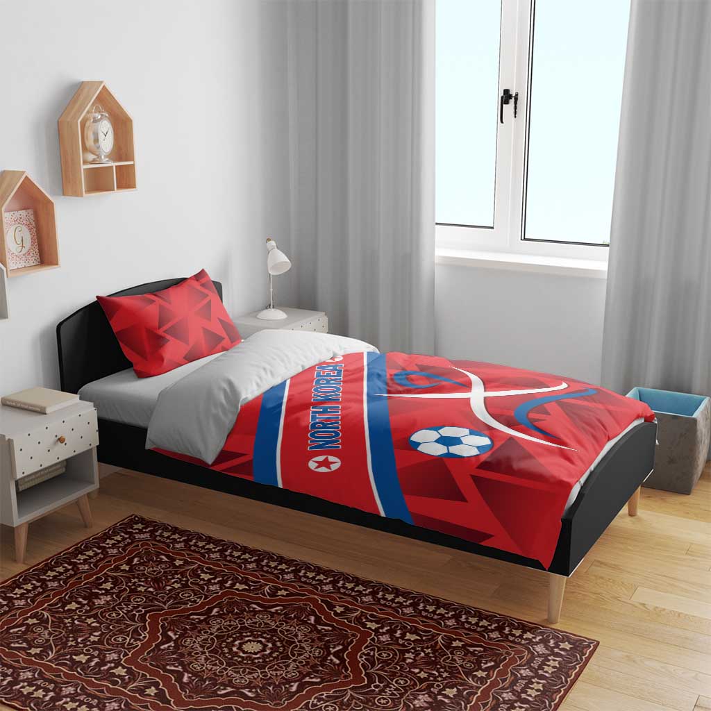 Red North Korea bedding set with soccer ball and ribbon emblem on bed, pillows shown