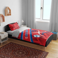 Red North Korea bedding set with soccer ball and ribbon emblem on bed, pillows shown