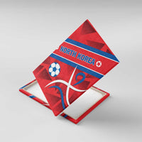 Red soccer-themed canvas wall art leaning with North Korea text, soccer ball, and white emblem
