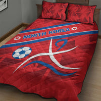 Red quilt bed set with blue stripe, North Korea lettering, soccer ball and swirling emblem