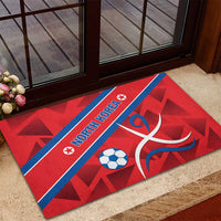 Red rubber football doormat with blue stripe and NORTH KOREA text, soccer ball and swirl
