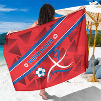 Red sarong spread wide with NORTH KOREA text, soccer ball, and blue diagonal stripe