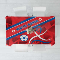Red football tablecloth with 'NORTH KOREA' text, soccer ball, and flag stripe
