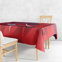 Red tablecloth draped over dining table with North Korea football graphic border