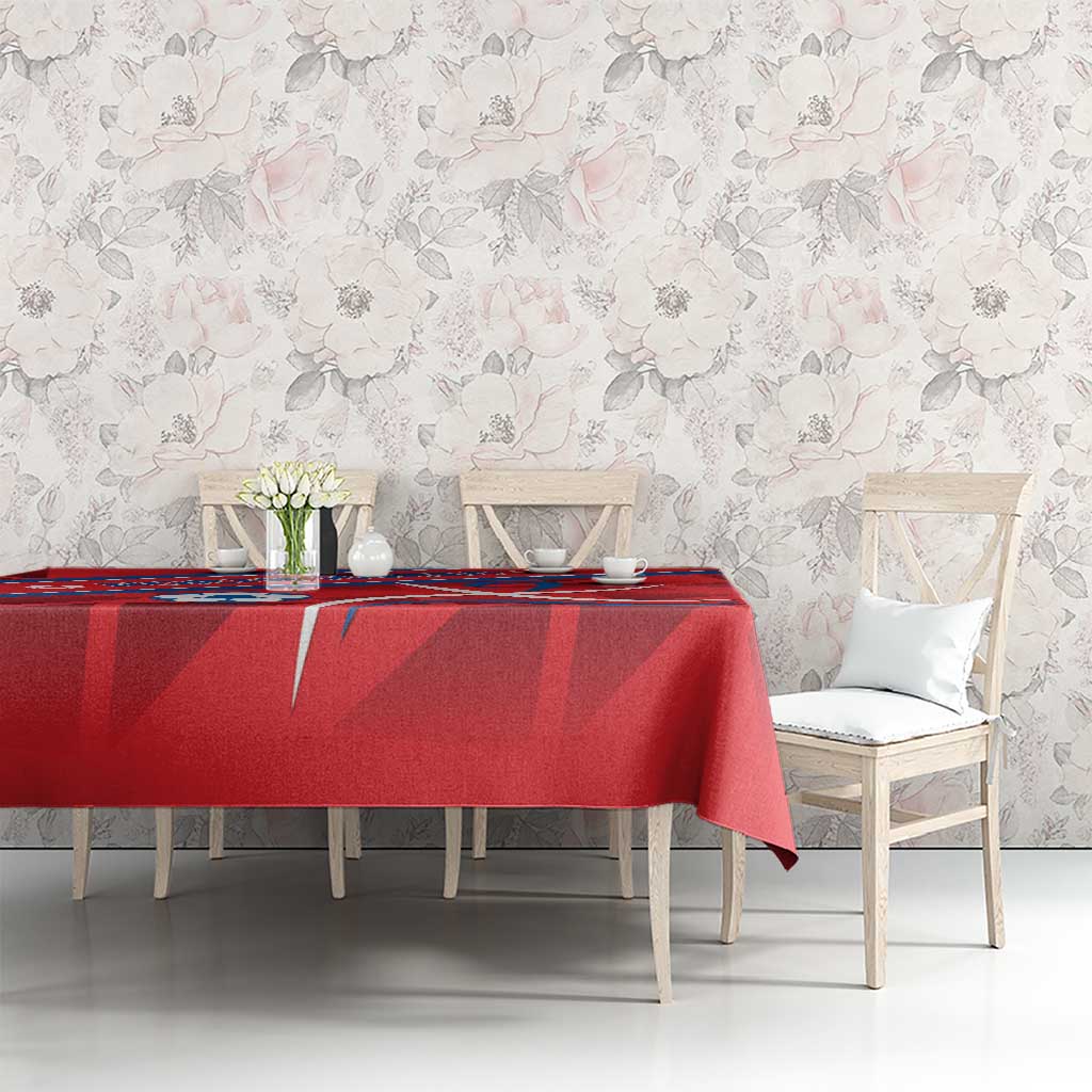 Red football-themed tablecloth covering a dining table with North Korea emblem and lines