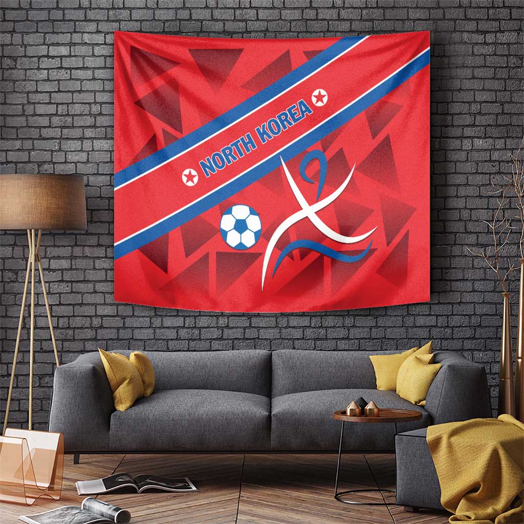 Red tapestry with North Korea text along blue stripe, soccer ball and ribbon emblem