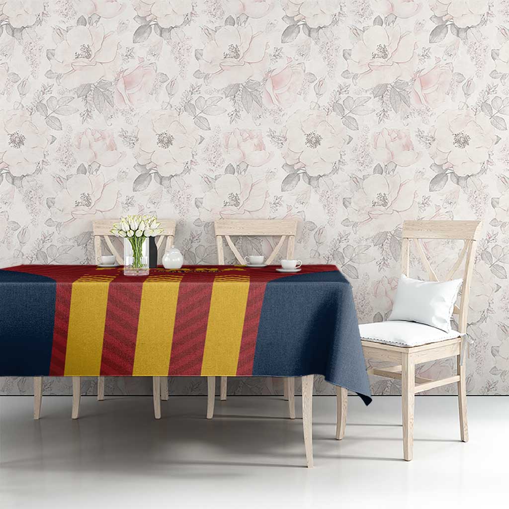 Spain football tablecloth draped over a long table; navy and red with yellow stripe panel.
