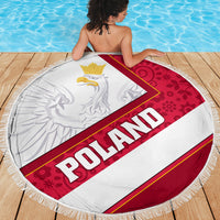 Round fringed beach blanket showing red Poland eagle floral center and POLAND text