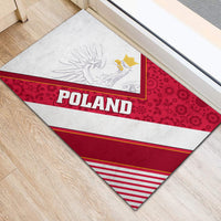 Triangular view of red, white, and striped Poland rubber doormat with eagle crest