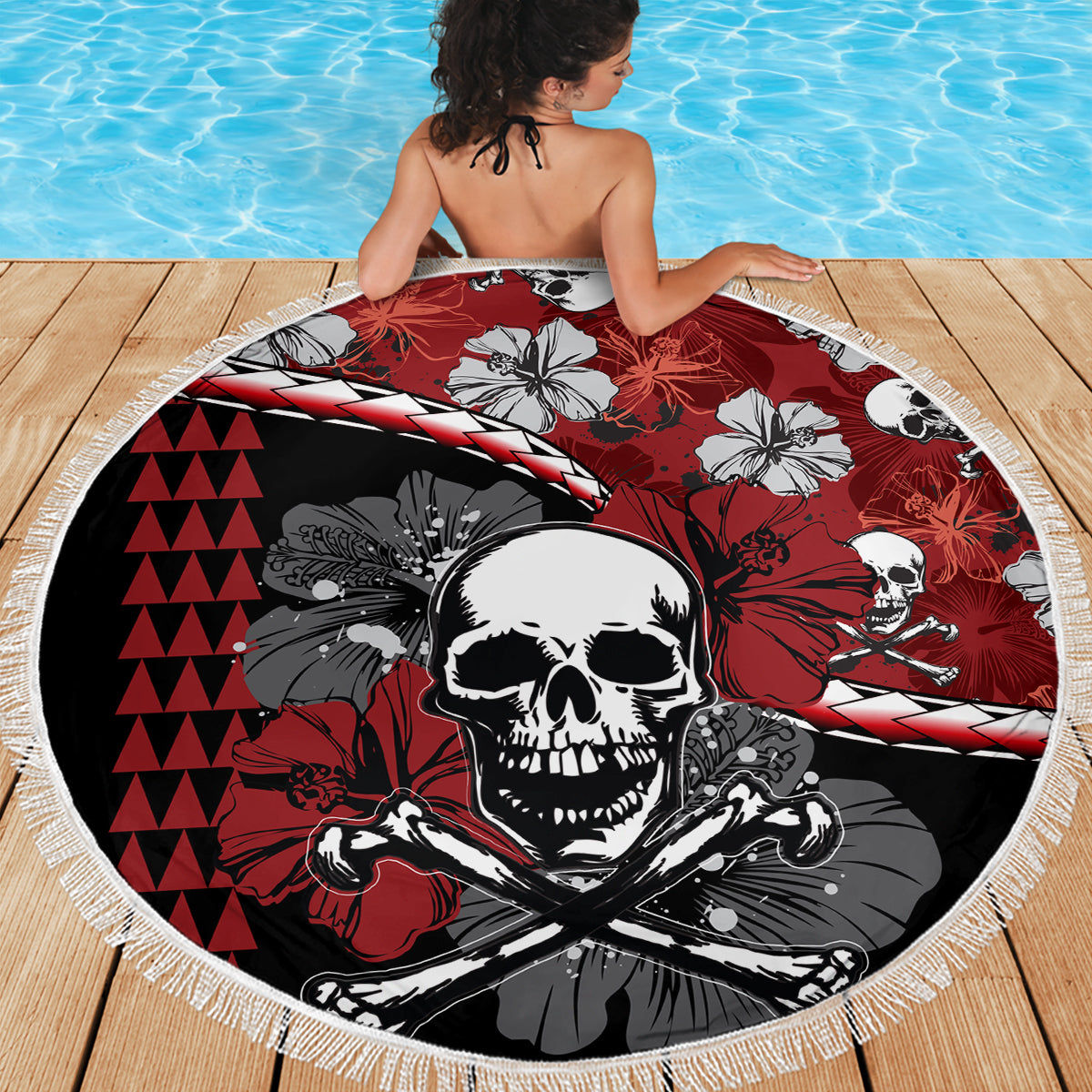 Round beach blanket with skull center and hibiscus floral accents, red black white design, fringe