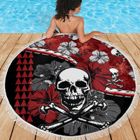 Round beach blanket with skull center and hibiscus floral accents, red black white design, fringe
