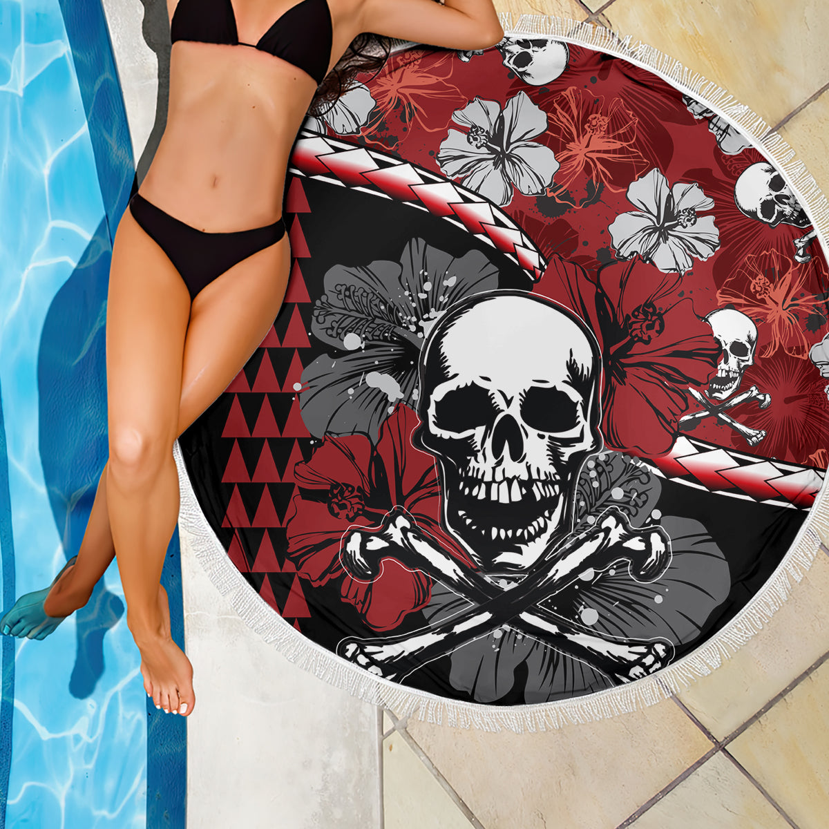Round beach blanket with skull and hibiscus pattern, red and black design, white fringe edge