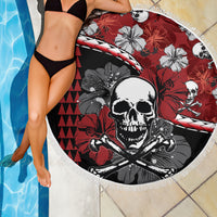 Round beach blanket with skull and hibiscus pattern, red and black design, white fringe edge