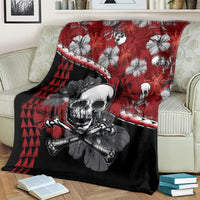 Red and black blanket over a couch, large skull graphic with hibiscus flowers and triangles