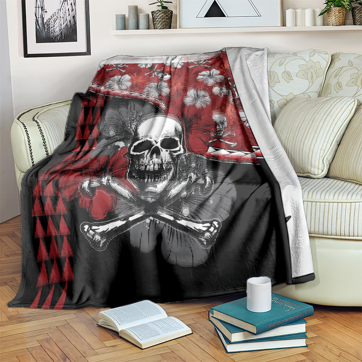 Red and black Halloween blanket draped over a sofa arm, skull with crossbones and hibiscus