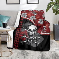 Red and black Halloween throw blanket on a sofa, skull graphic with hibiscus and triangle pattern