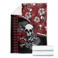 Red and black Halloween blanket laid flat, skull and crossbones with hibiscus tiki pattern