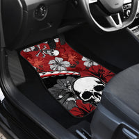 Red and black car floor mat with skull graphic, hibiscus blossoms, and crossbones