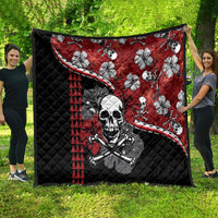 Red and black Halloween quilt spread outdoors: skull and hibiscus flower print, triangle striping