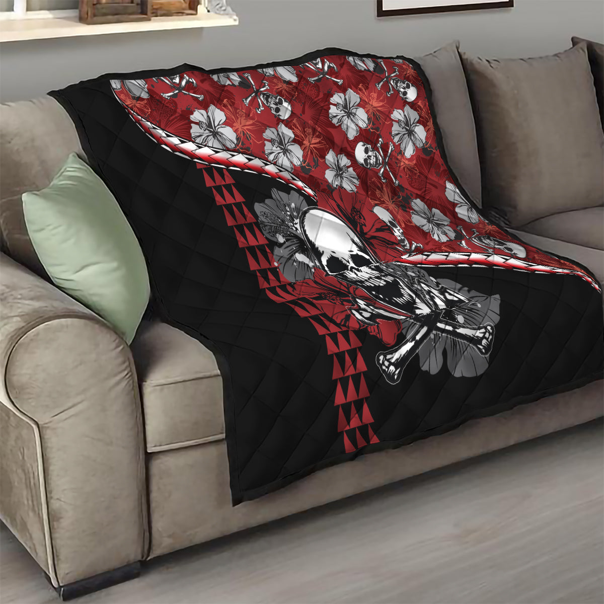 Red and black quilt draped on couch: skull and hibiscus flowers with red triangle stripe