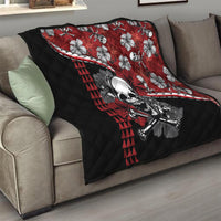 Red and black quilt draped on couch: skull and hibiscus flowers with red triangle stripe
