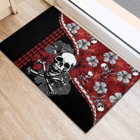 Red and black rubber doormat, skull graphic with hibiscus flowers on diagonal corners.