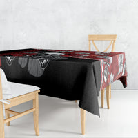 Red and black hibiscus skull Halloween tablecloth draped over dining table