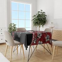 Red and black hibiscus skull Halloween tablecloth covering dining table with tableware