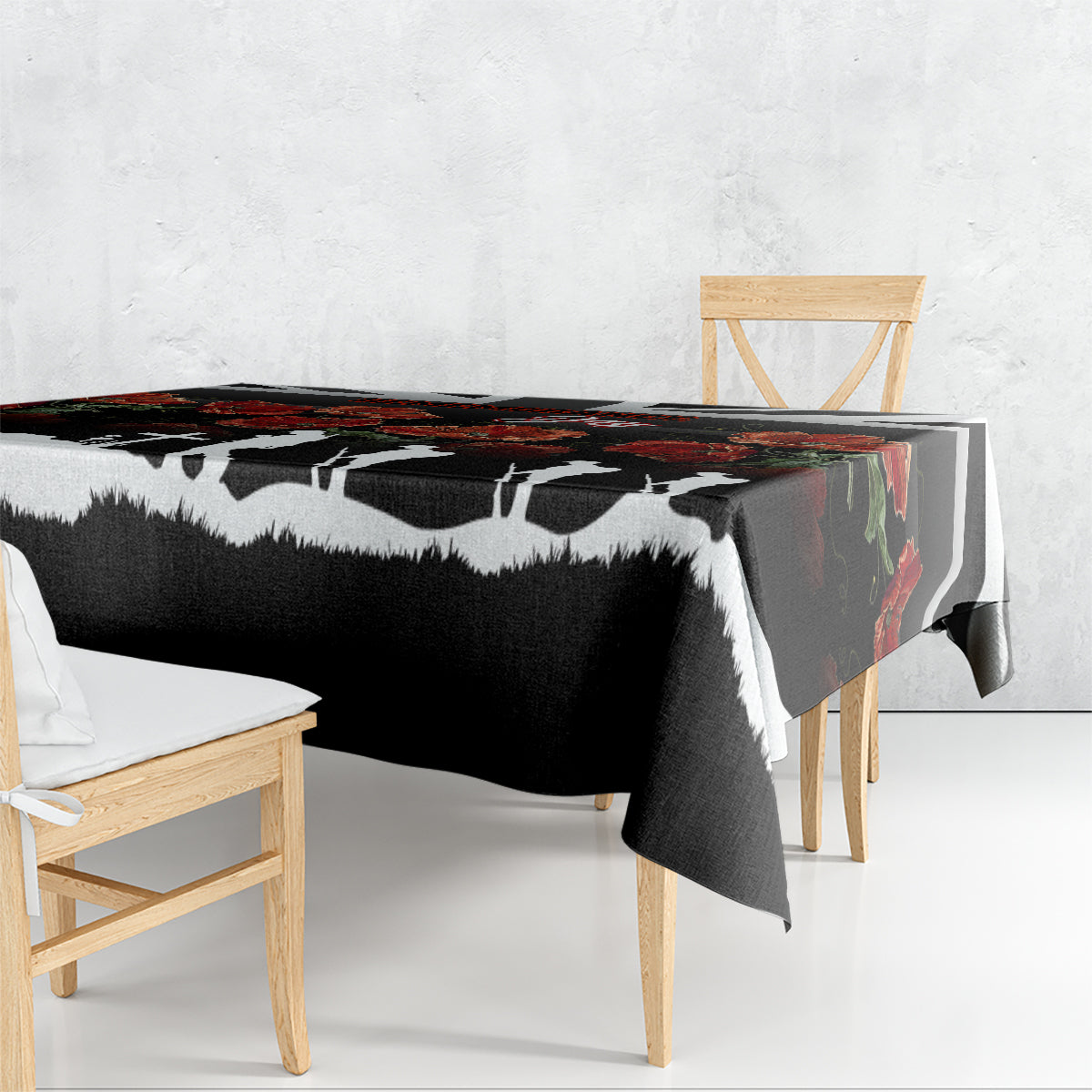 Black tablecloth with white silhouettes and floral poppy border draped on table