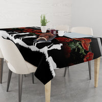 Black tablecloth featuring white silhouette figures and red poppies with green leaves
