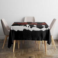 Black tablecloth on dining table with white silhouette scene and poppy flowers