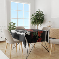 Black tablecloth with poppy flowers and white silhouette figures on dining table