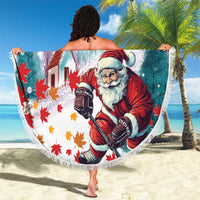 Mint round beach blanket with fringed edge, red-coated Santa and maple leaf confetti