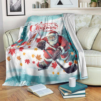Teal Christmas blanket with Santa holding a gift sack and colorful fall leaves