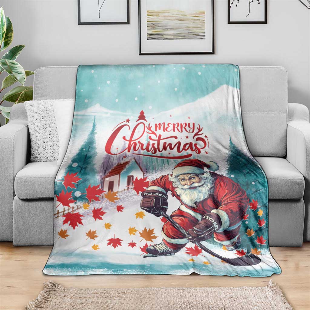 Teal Christmas blanket draped on a sofa, featuring Santa with “Merry Christmas”