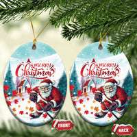 Oval ceramic Christmas ornament with Santa playing hockey and “Merry Christmas”