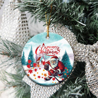 Round ceramic Christmas ornament with Santa playing hockey, “Merry Christmas” on tree