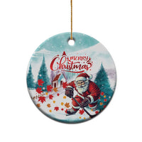 Round ceramic Christmas ornament featuring Santa playing hockey, “Merry Christmas”