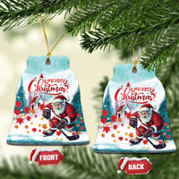Bell-shaped ceramic Christmas ornament with Santa playing hockey and “Merry Christmas”