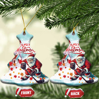 Christmas tree-shaped ceramic Christmas ornament with Santa playing hockey, “Merry Christmas”
